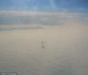 Mysterious shadow figure walking on clouds plane passenger (1)[1].jpg